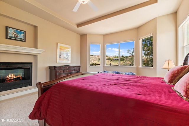 7601 Autumn Ridge Cir, Reno, NV 89523 - carpeted bedroom featuring a glass covered fireplace and a ceiling fan