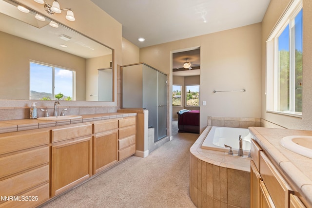 7601 Autumn Ridge Cir, Reno, NV 89523 - bathroom featuring vanity, a bath, a ceiling fan, and a shower with shower door
