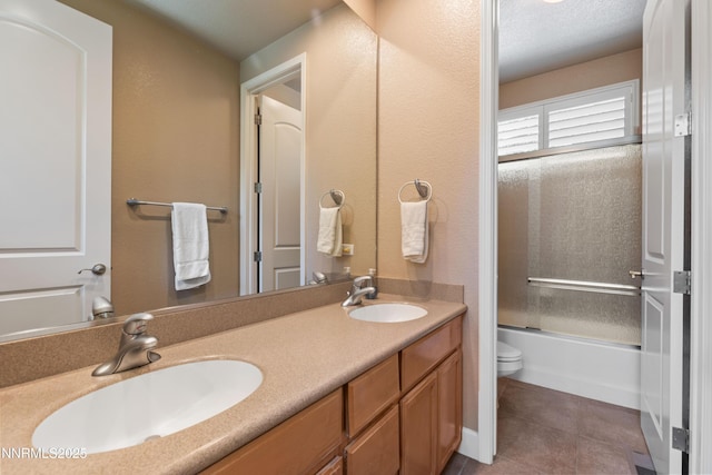 7601 Autumn Ridge Cir, Reno, NV 89523 - bathroom featuring double vanity, tile patterned flooring, and combined bath / shower with glass door