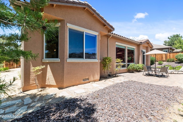 7601 Autumn Ridge Cir, Reno, NV 89523 - rear view of house featuring a patio, stucco siding, and a tile roof