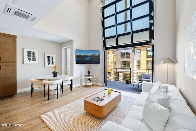 3816 Lakeside Dr Unit 9, Reno, NV 89509 - living area with a towering ceiling, light wood-style floors, and baseboards