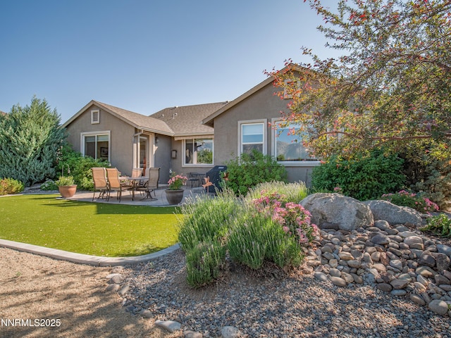 1221 Lasso Ln, Gardnerville, NV 89410 - rear view of house featuring stucco siding, a patio, and a yard