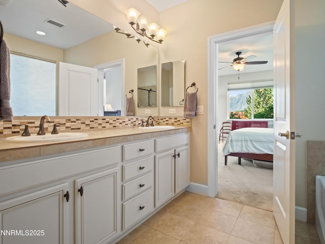 1221 Lasso Ln, Gardnerville, NV 89410 - ensuite bathroom with double vanity, tasteful backsplash, tile patterned flooring, and a ceiling fan