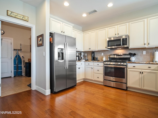 1221 Lasso Ln, Gardnerville, NV 89410 - kitchen featuring stainless steel appliances, decorative backsplash, light stone counters, recessed lighting, and light wood-style flooring