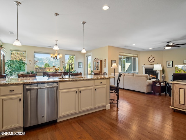 1221 Lasso Ln, Gardnerville, NV 89410 - kitchen with stainless steel dishwasher, a warm lit fireplace, ceiling fan, wood finished floors, and open floor plan