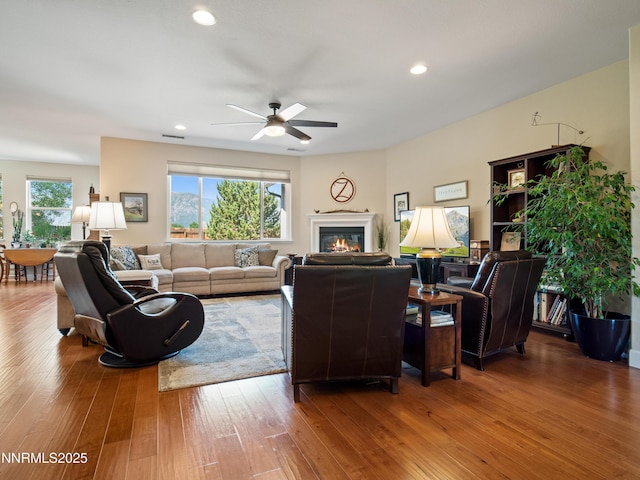 1221 Lasso Ln, Gardnerville, NV 89410 - living room featuring a ceiling fan, hardwood / wood-style floors, a glass covered fireplace, and recessed lighting