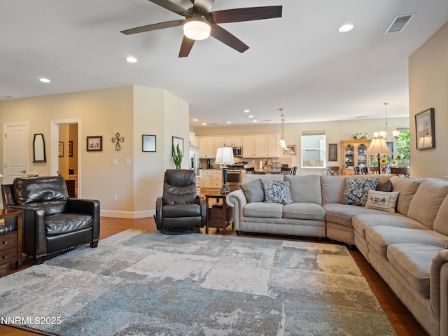 1221 Lasso Ln, Gardnerville, NV 89410 - living room featuring ceiling fan, dark wood-style flooring, recessed lighting, and a chandelier