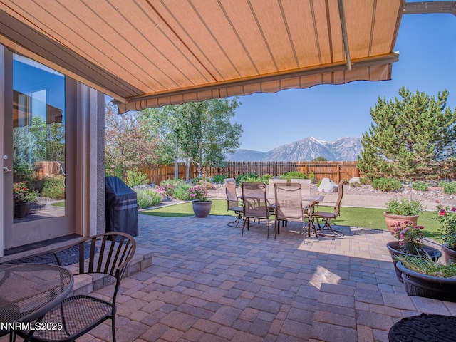 1221 Lasso Ln, Gardnerville, NV 89410 - fenced backyard with a mountain view, outdoor dining space, and a patio