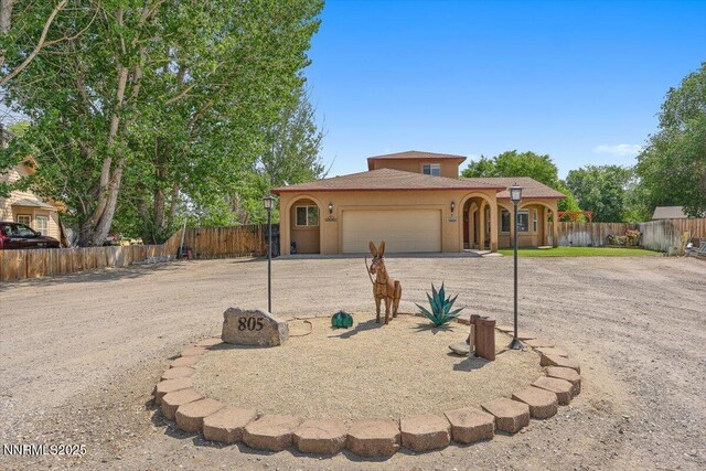 805 Samantha Cir, Fallon, NV 89406 - mediterranean / spanish house featuring an attached garage, driveway, and stucco siding