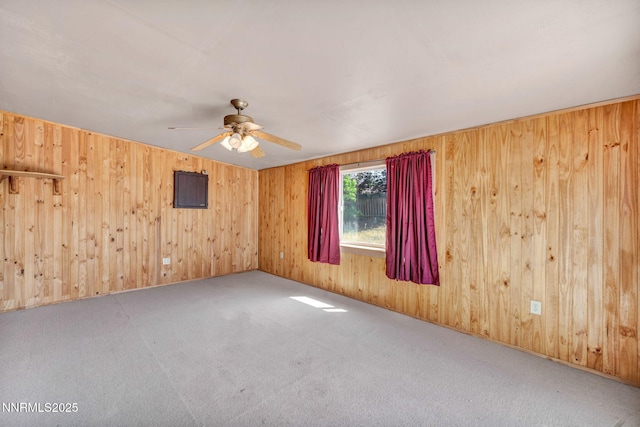 1331 Victoria Dr, Gardnerville, NV 89460 - carpeted spare room featuring ceiling fan and wood walls
