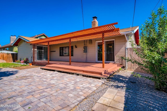 715 Emerson Way, Sparks, NV 89431 - rear view of house featuring a patio, a chimney, and a wooden deck