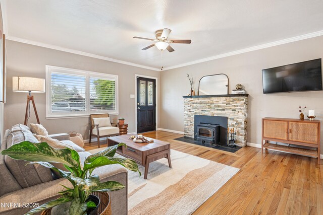2441 Riviera St, Reno, NV 89509 - living area with ceiling fan, a wood stove, wood finished floors, crown molding, and baseboards