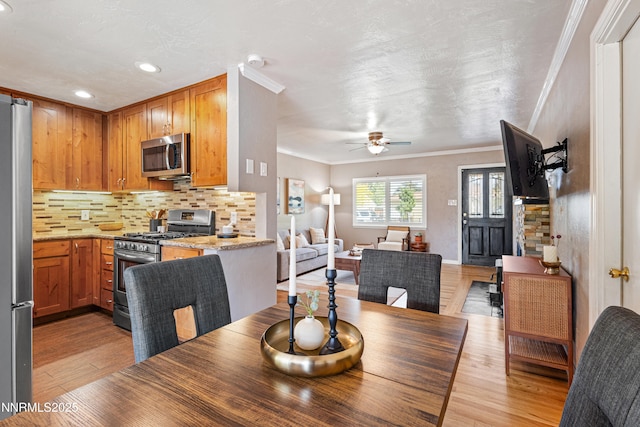 2441 Riviera St, Reno, NV 89509 - dining space with crown molding, light wood-style flooring, a ceiling fan, and recessed lighting