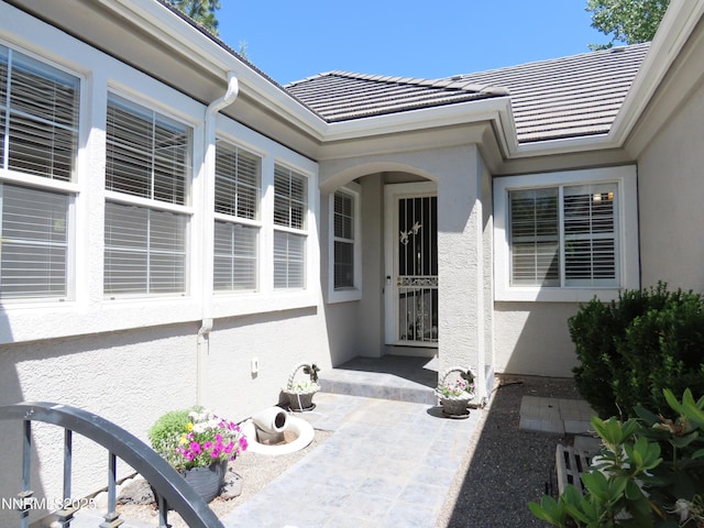 1570 Caughlin Creek Rd, Reno, NV 89519 - doorway to property with stucco siding and a tiled roof
