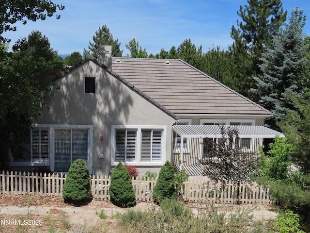 1570 Caughlin Creek Rd, Reno, NV 89519 - back of house with a chimney, stucco siding, a tile roof, and a pergola