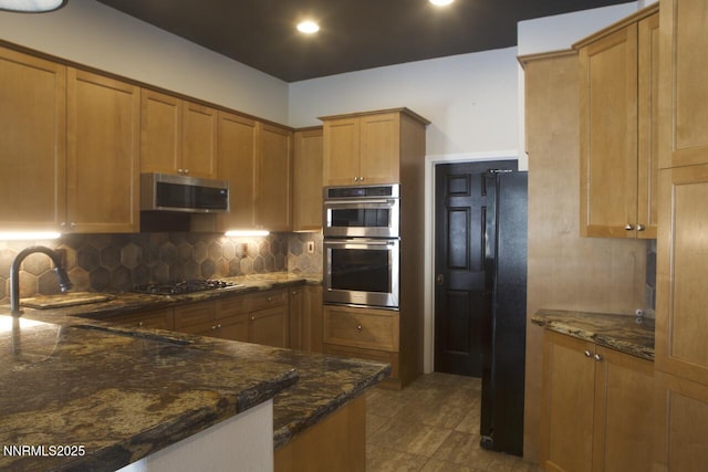 1570 Caughlin Creek Rd, Reno, NV 89519 - kitchen with black appliances, backsplash, dark stone counters, brown cabinets, and recessed lighting