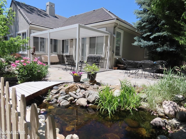 1570 Caughlin Creek Rd, Reno, NV 89519 - rear view of property with a patio area, a chimney, a tiled roof, and stucco siding