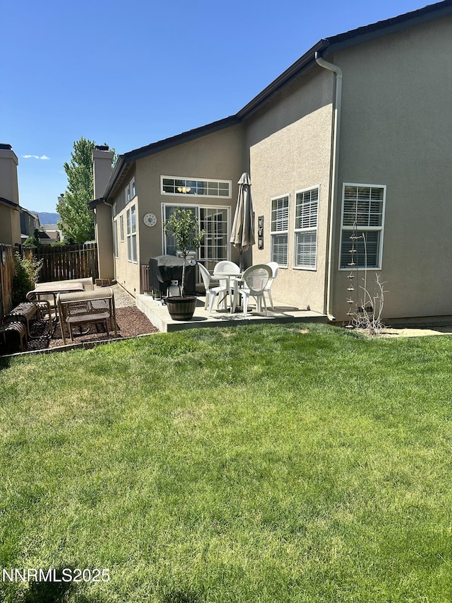 2787 Foxhill Dr, Carson City, NV 89706 - back of house featuring a patio, stucco siding, and a chimney
