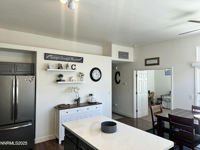 2787 Foxhill Dr, Carson City, NV 89706 - kitchen featuring freestanding refrigerator, dark wood-style flooring, ceiling fan, a textured ceiling, and baseboards
