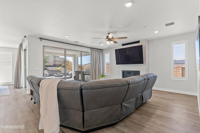 5419 Fossilstone Dr, Sparks, NV 89436 - living area with ceiling fan, a fireplace, baseboards, plenty of natural light, and recessed lighting