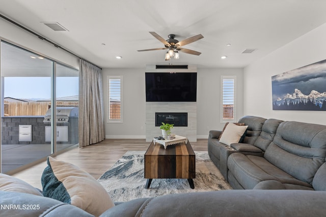 5419 Fossilstone Dr, Sparks, NV 89436 - living room with light wood finished floors, baseboards, ceiling fan, recessed lighting, and a large fireplace