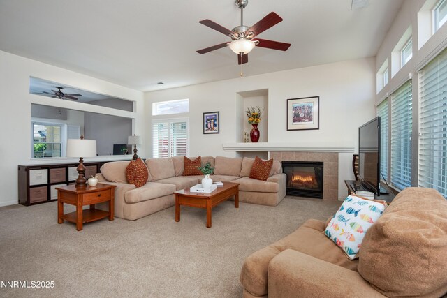 1781 Glen Cove Ct, Reno, NV 89521 - living room with a ceiling fan, a tiled fireplace, plenty of natural light, and carpet floors