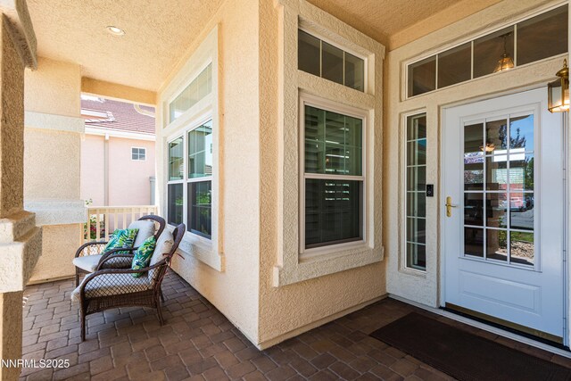 1781 Glen Cove Ct, Reno, NV 89521 - doorway to property with stucco siding and a porch