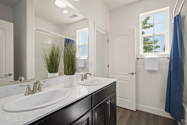 10450 Palladium Mine Dr, Reno, NV 89521 - full bathroom featuring a shower with shower curtain, double vanity, wood finished floors, and baseboards