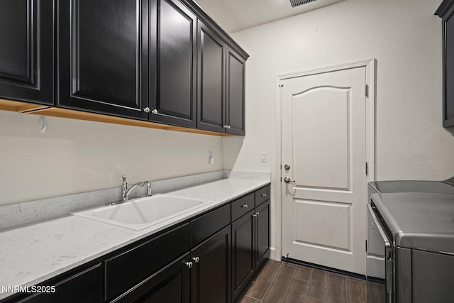 10450 Palladium Mine Dr, Reno, NV 89521 - washroom featuring cabinet space, dark wood-style floors, and washing machine and dryer