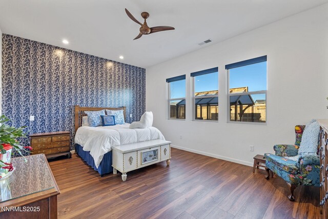 7415 Hoback Dr, Sparks, NV 89436 - bedroom with an accent wall, baseboards, wood finished floors, wallpapered walls, and recessed lighting