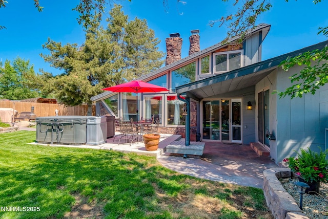 12245 Spruce Ln, Reno, NV 89511 - back of property with a hot tub, a chimney, and a patio