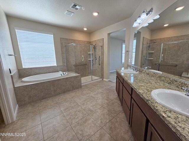 217 Bristol Wells Ct, Spanish Springs, NV 89441 - bathroom with a stall shower, a garden tub, double vanity, tile patterned flooring, and recessed lighting