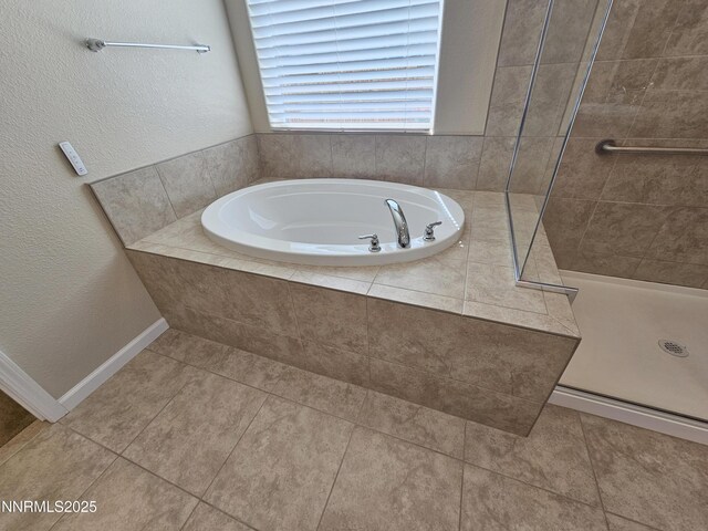 217 Bristol Wells Ct, Spanish Springs, NV 89441 - full bath featuring a stall shower, a garden tub, tile patterned flooring, and a textured wall