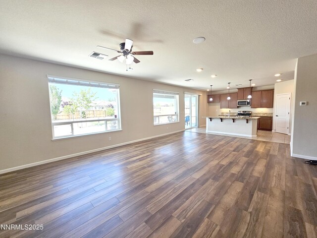 217 Bristol Wells Ct, Spanish Springs, NV 89441 - unfurnished living room with a ceiling fan, dark wood-style flooring, baseboards, and recessed lighting