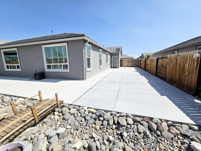 217 Bristol Wells Ct, Spanish Springs, NV 89441 - view of property exterior featuring a fenced backyard, a patio, and stucco siding