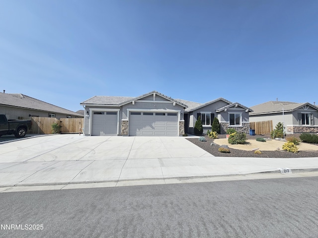 217 Bristol Wells Ct, Spanish Springs, NV 89441 - view of front of home featuring stone siding, an attached garage, driveway, and stucco siding