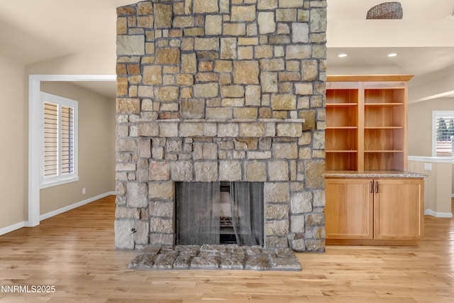 3467 Skyline Blvd, Reno, NV 89509 - detailed view of a stone fireplace, wood finished floors, baseboards, and recessed lighting