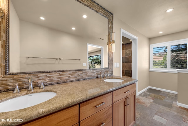 3467 Skyline Blvd, Reno, NV 89509 - full bathroom featuring stone tile floors, baseboards, backsplash, double vanity, and recessed lighting