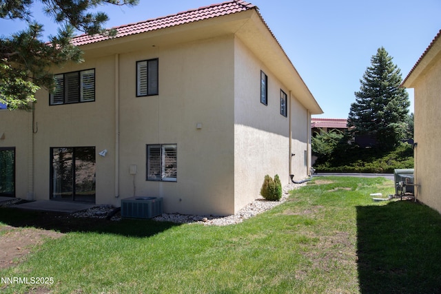 3467 Skyline Blvd, Reno, NV 89509 - rear view of property featuring stucco siding, a tiled roof, a yard, and central AC unit