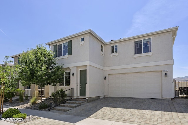 3621 Pimlico St, Reno, NV 89512 - view of front of home featuring stucco siding, an attached garage, and decorative driveway