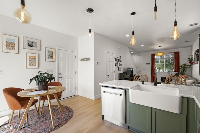 3621 Pimlico St, Reno, NV 89512 - kitchen with green cabinetry, dishwasher, light wood-style flooring, light countertops, and pendant lighting