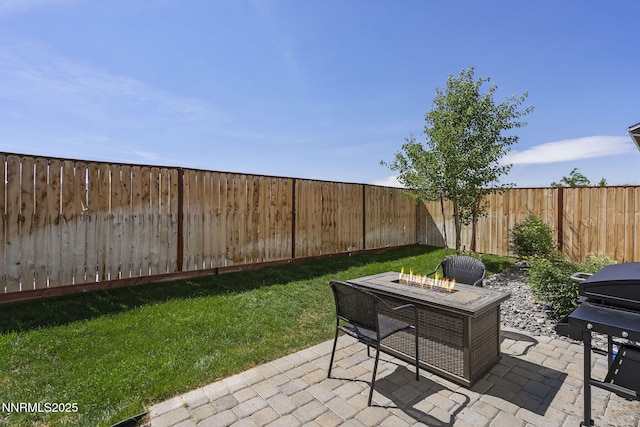3621 Pimlico St, Reno, NV 89512 - fenced backyard featuring grilling area, an outdoor fire pit, and a patio