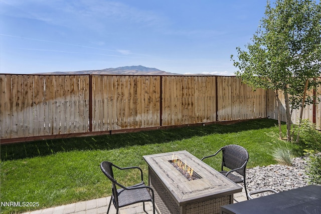 3621 Pimlico St, Reno, NV 89512 - fenced backyard featuring an outdoor fire pit and a mountain view