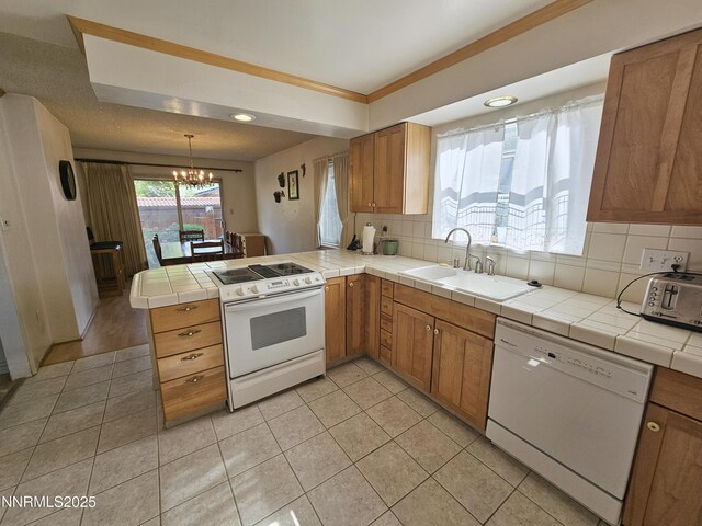 55 E Richards Way, Sparks, NV 89431 - kitchen featuring white appliances, a sink, a peninsula, a chandelier, and backsplash