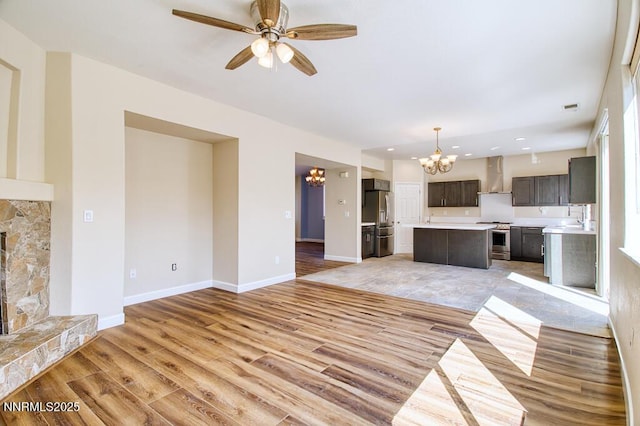 10595 Baton Ct, Reno, NV 89521 - unfurnished living room featuring a chandelier, light wood finished floors, ceiling fan, baseboards, and recessed lighting