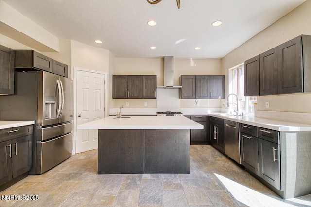 10595 Baton Ct, Reno, NV 89521 - kitchen featuring wall chimney exhaust hood, appliances with stainless steel finishes, a center island with sink, a sink, and dark brown cabinetry