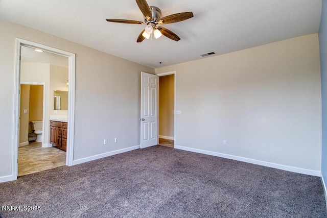 10595 Baton Ct, Reno, NV 89521 - unfurnished bedroom featuring light colored carpet, baseboards, ensuite bath, and a ceiling fan