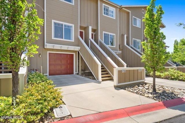 4136 Kathleen Denise Ln, Reno, NV 89503 - view of property featuring driveway, an attached garage, and board and batten siding
