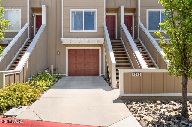 4136 Kathleen Denise Ln, Reno, NV 89503 - entrance to property with concrete driveway, board and batten siding, and a garage