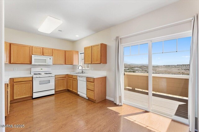 4136 Kathleen Denise Ln, Reno, NV 89503 - kitchen featuring white appliances, light wood-style flooring, light countertops, and baseboards